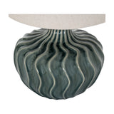 Hill Interiors ceramic table lamp base in glazed dark grey with a rippled wave texture, topped by a natural linen shade, on a plain background.
