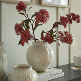 Hill Interiors Round Ceramic Vase 22cm in white with a ribbed rounded body, holding red bloom stems on a sideboard beside a smaller matching vase.