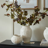 Hill Interiors Ceramic Olpe Vase in white with textured ribbed body, holding tall autumnal leaf stems on a dark sideboard beside a smaller matching vase.