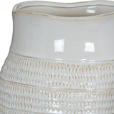Close-up of the Hill Interiors Hewn Bud Vase in white ceramic, showing its glossy glaze and textured bands of carved teardrop detailing around the base.