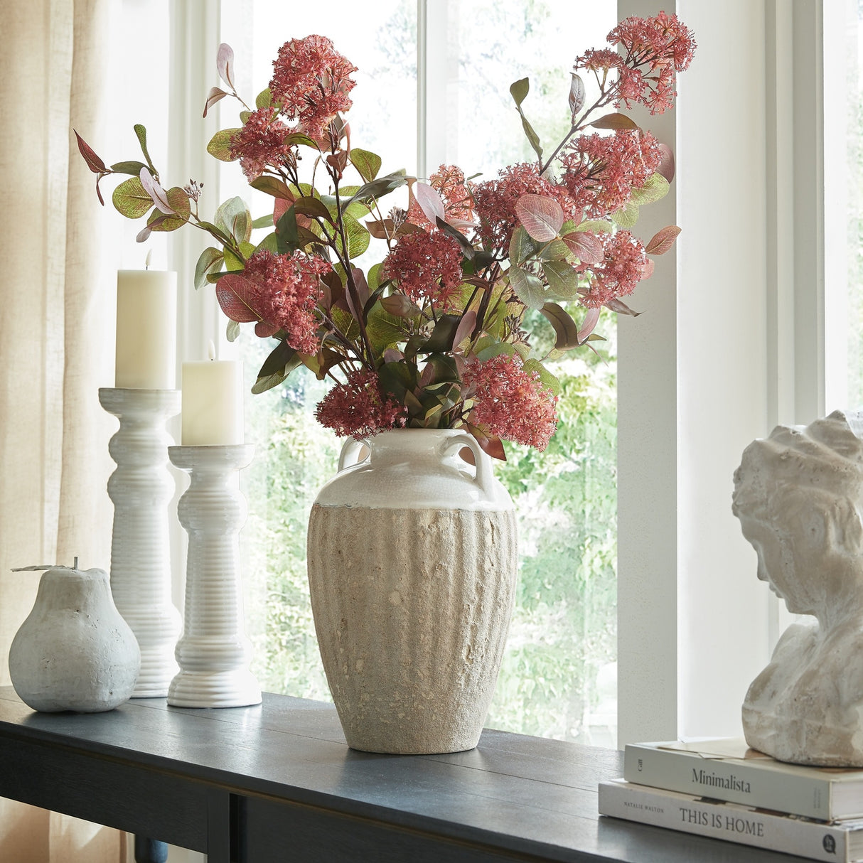 Hill Interiors Large Amphora Vase in white ceramic with a ribbed textured body, holding pink blossom stems on a console beside candle holders and a bust.