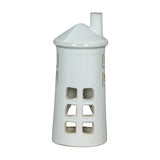 Hill Interiors Large Lighthouse Tealight Holder in white ceramic, with tapered tiered form, cut-out windows and slim chimney top, on a plain background.