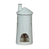 Hill Interiors Large Lighthouse Tealight Holder in white ceramic, with tapered tiered form, arched cut-out window and slim chimney, on a plain background.