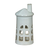 Hill Interiors Medium Lighthouse ceramic tealight holder in white, with tapered tower, cut-out windows and chimney top, shown on a plain background.