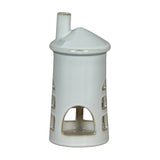 Hill Interiors Medium Lighthouse ceramic tealight holder in white with tapered tower, arched openings and chimney top, shown on a plain background.