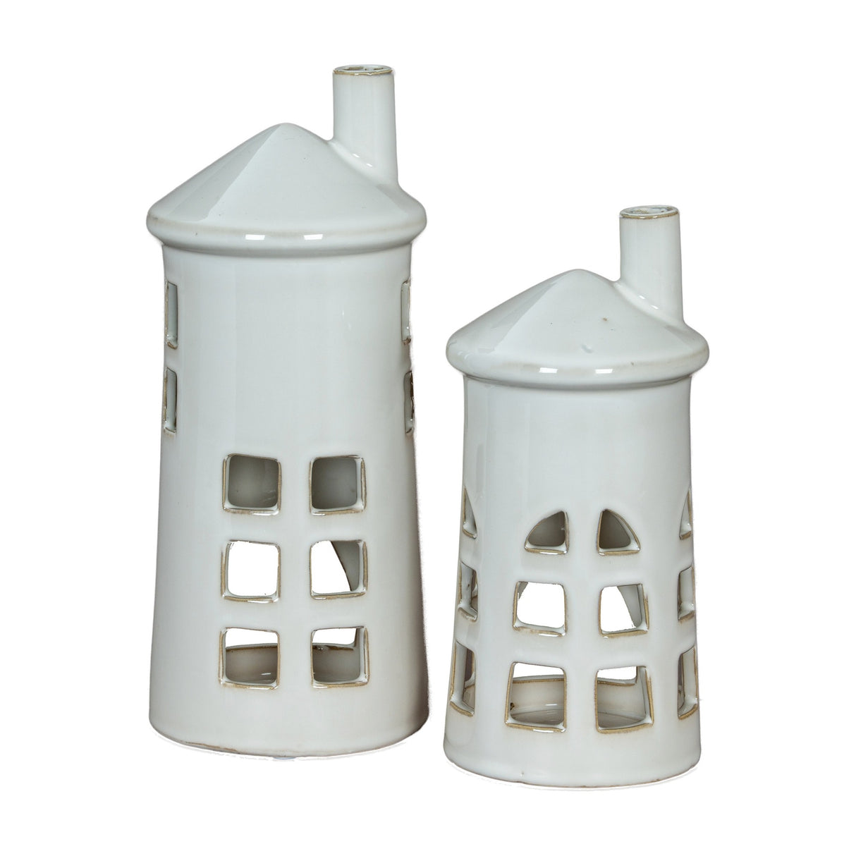 Hill Interiors Medium Lighthouse ceramic tealight holders in white, shown as a pair in tapered tower shapes with cut-out windows and chimney tops.