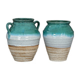 Pair of Hill Interiors ceramic amphora vases with turquoise glazed tops, white middles and sandy bases, one with twin handles, on a white background.