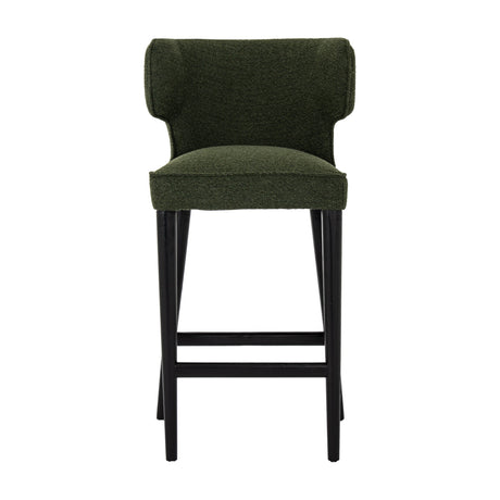 Hill Interiors Quennomer Barstool in moss green woven upholstery with a curved wingback seat and slim black wooden legs, shown on a white background.
