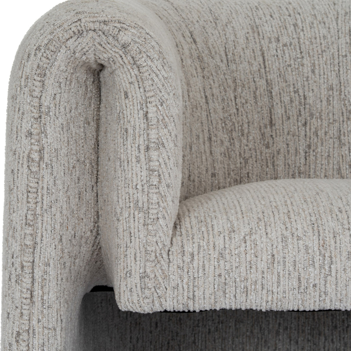 Close-up of the Hill Interiors Quennomer accent armchair showing the curved wraparound back and padded seat in textured soft grey upholstery.