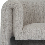 Close-up of the Hill Interiors Quennomer accent armchair showing the curved wraparound back and padded seat in textured soft grey upholstery.