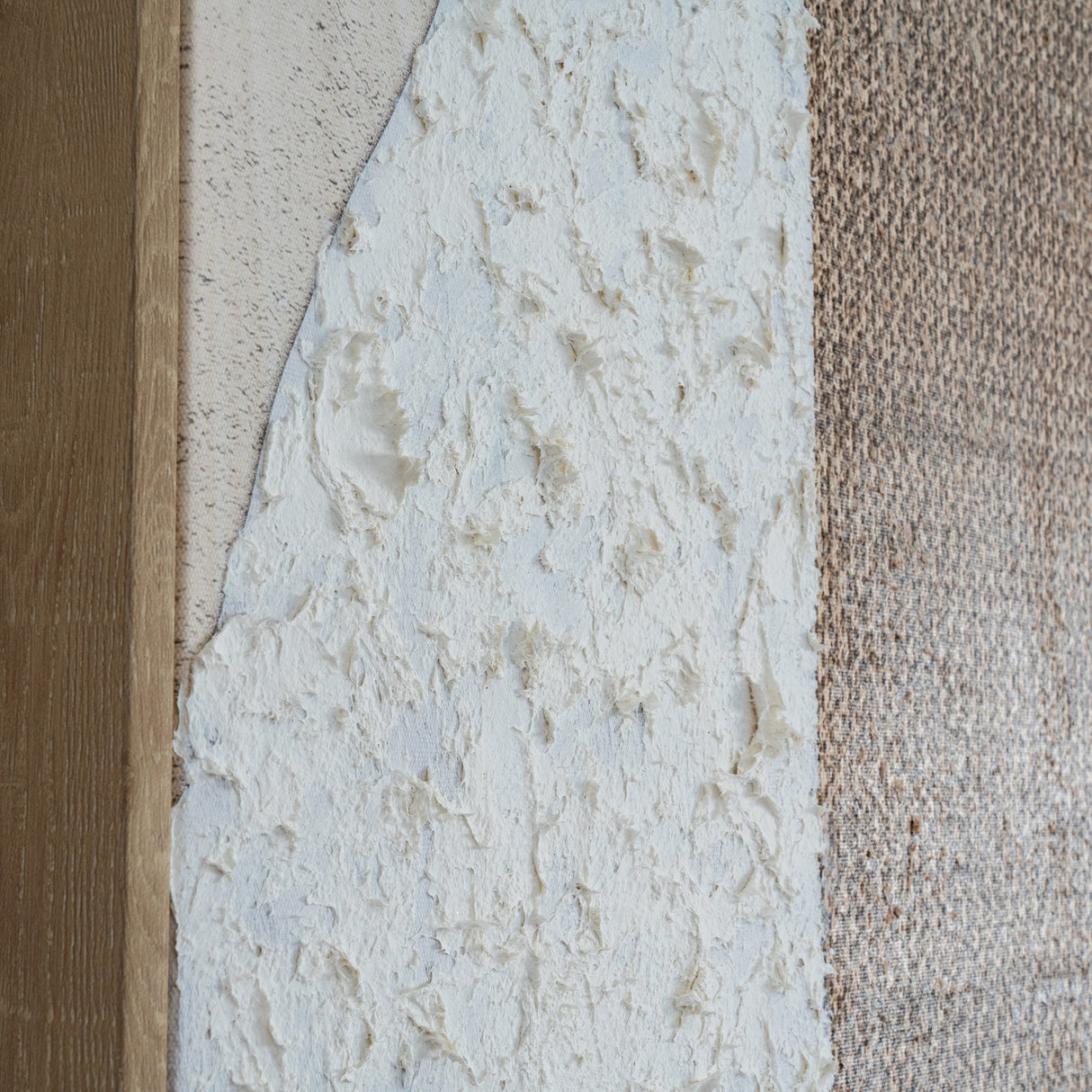 Close-up of Hill Interiors Hand Painted Canvas showing thick white textured brushwork against a beige background, edged by a slim wood frame.