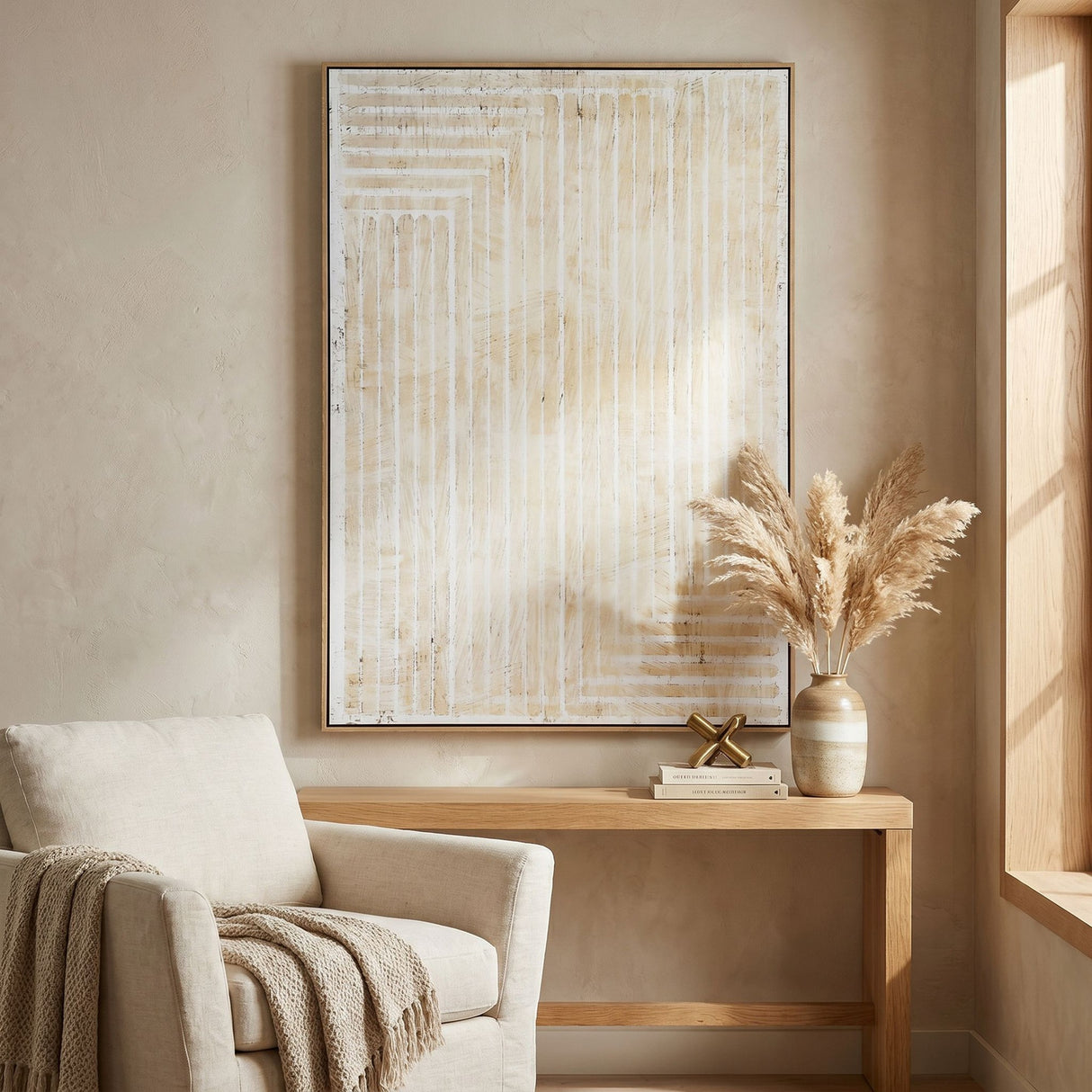 Hill Interiors hand painted canvas wall art in a wooden frame, featuring cream and beige linear brushstrokes, hung above a console table in a living room.