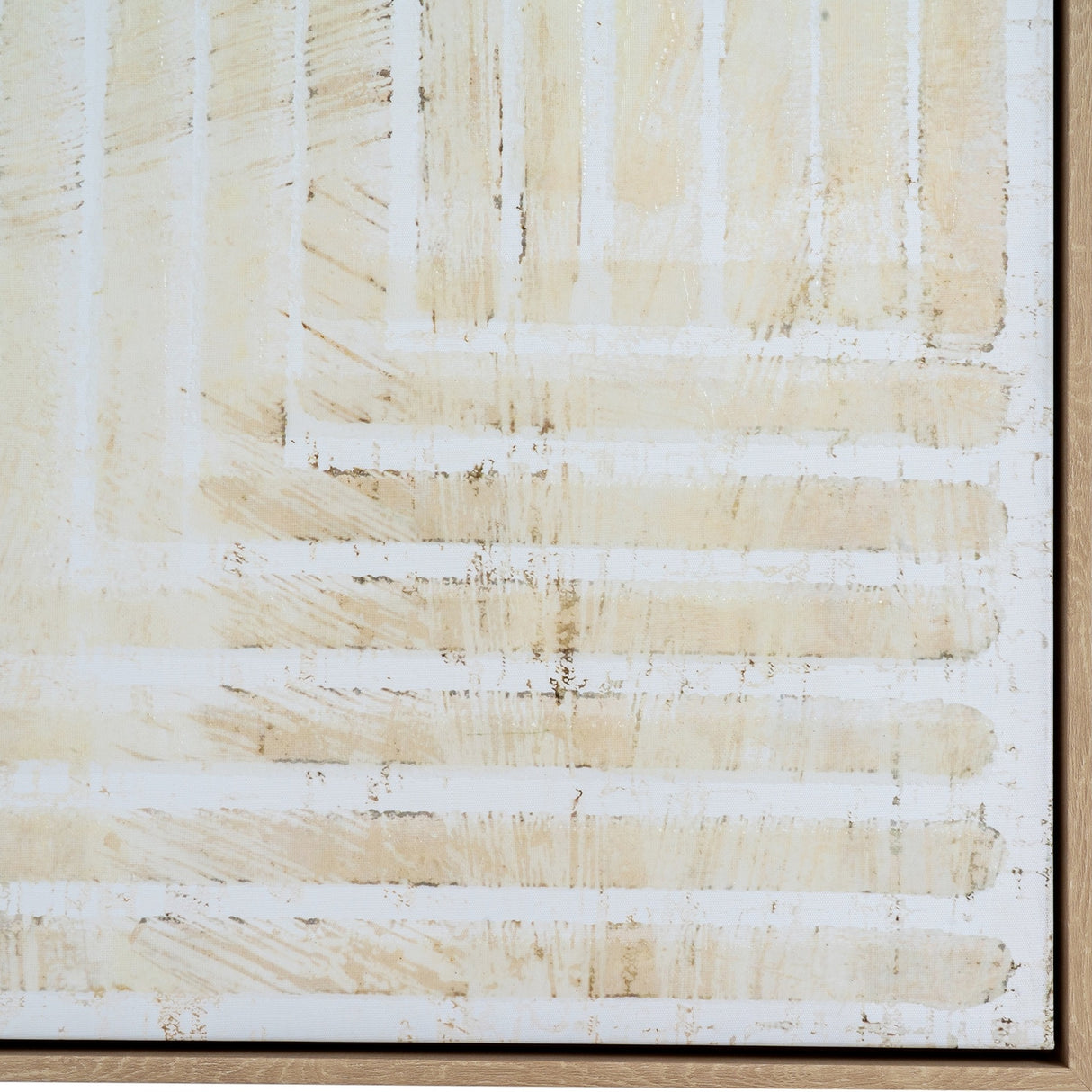 Close-up of Hill Interiors hand painted canvas wall art showing layered cream and beige brushstrokes over a white ground, set within a light wooden frame.