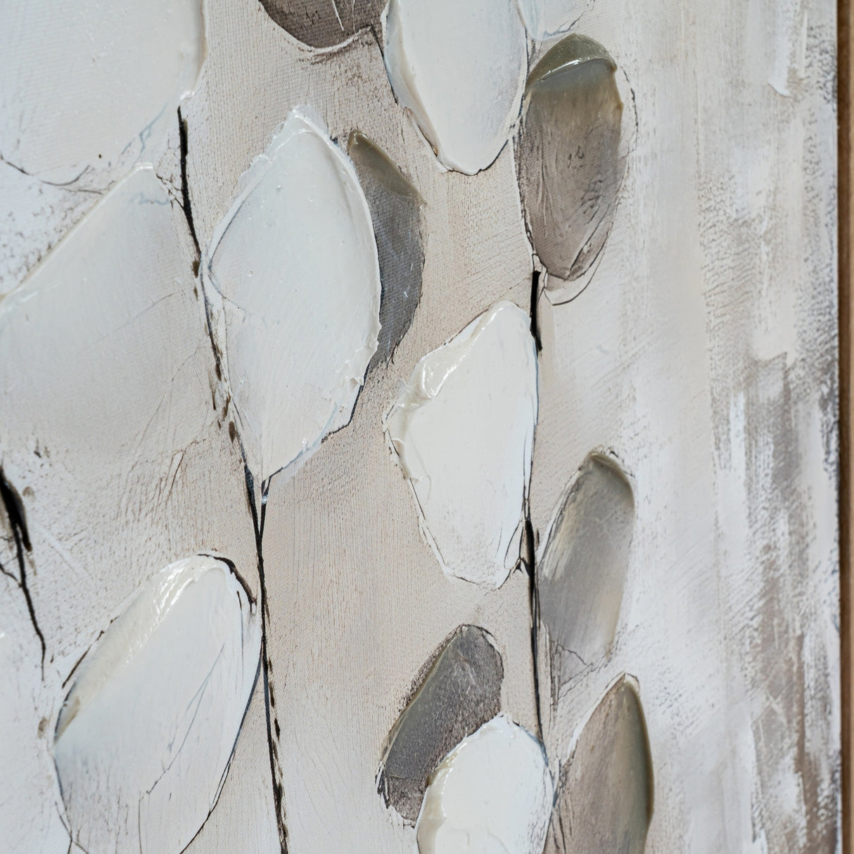 Close-up of Hill Interiors hand painted canvas wall art showing textured white and grey petal-like brushstrokes on a neutral background within a wooden frame.