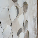 Close-up of Hill Interiors hand painted canvas wall art showing textured white and grey petal-like brushstrokes on a neutral background within a wooden frame.