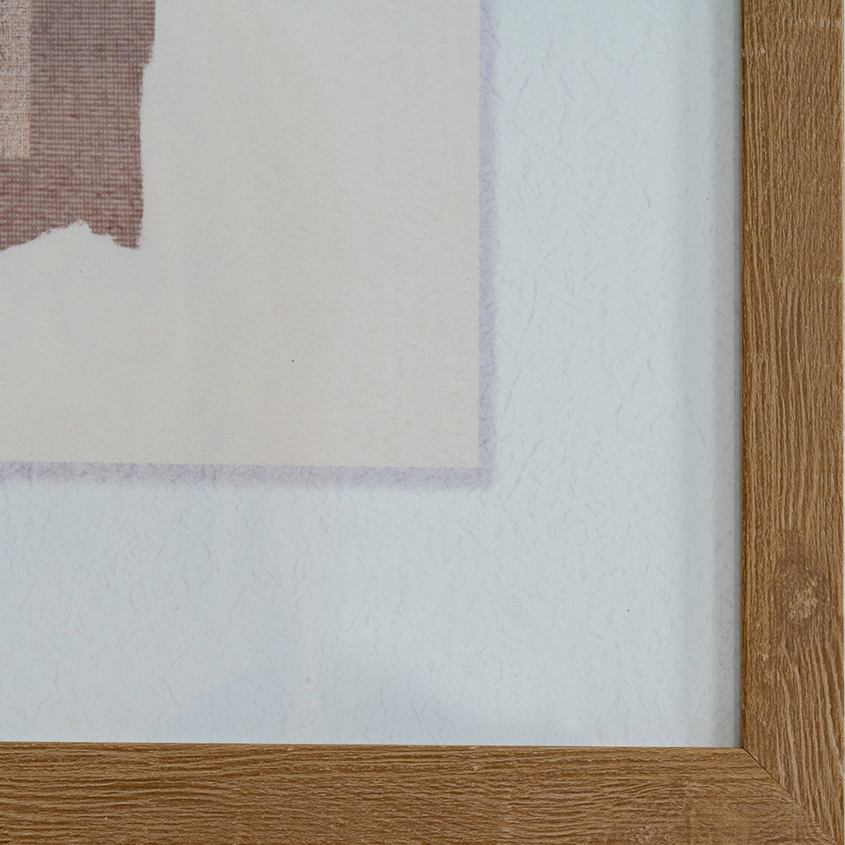Close-up corner detail of the Hill Interiors Framed Terrain Print Wall Art showing the wooden frame and soft multicoloured overlapping tones of the print.
