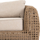 Close-up of Hill Interiors Outdoor Metal Garden Sofa in brown, showing the woven lattice arm detail and neutral beige seat and back cushions.