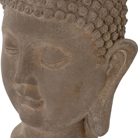 Close-up of Hill Interiors Buddha Head concrete planter in brown, showing the serene face, coiled hair detail and elongated ear against a white background.