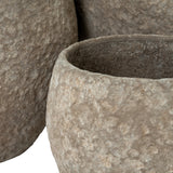 Close-up of Hill Interiors Pot Belly concrete planters in brown, showing the mottled textured surface and rounded forms with wide open tops.