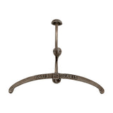 Hill Interiors silver metal coat hanger with curved arms embossed Hotel de Paris, topped by a hook and domed knob, shown on a plain white background.