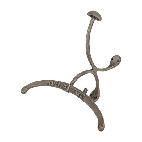 Hill Interiors silver metal coat hanger with curved arms, upper hook and embossed Hotel de Paris lettering, shown against a plain white background.