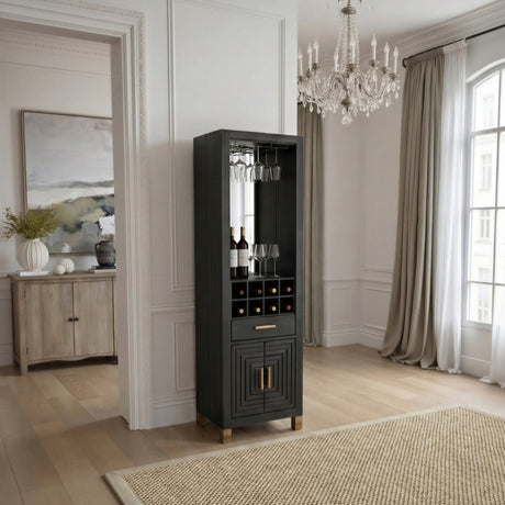 Hill Interiors Harweld tall black wooden drinks cabinet with wine bottle slots, glassware rack, drawer and lower doors, styled in a bright dining room.