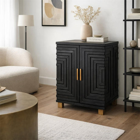 Hill Interiors Harweld two door side cabinet in black wood with geometric layered door fronts and brass handles, styled beside a boucle armchair.