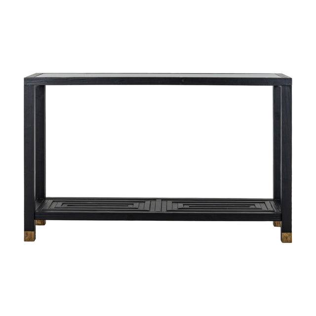 Hill Interiors Harweld console table with clear glass top, black wood frame, lower slatted shelf with geometric detail and brass-toned feet, on white.
