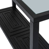 Close-up of the Hill Interiors Harweld black console table showing its toughened glass top, black frame, and geometric panel detail on the lower shelf.
