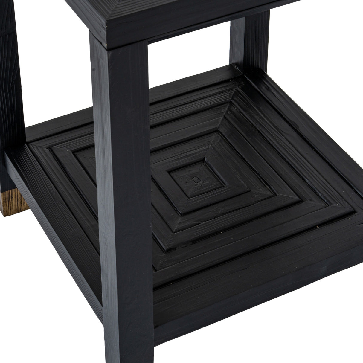 Close-up of the Hill Interiors Harweld wooden side table in matt black, showing the lower square shelf with concentric raised panelling and squared legs.