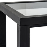 Close-up of the Hill Interiors Harweld wooden side table in matt black, showing the square glass-inset top and solid timber leg against a white background.