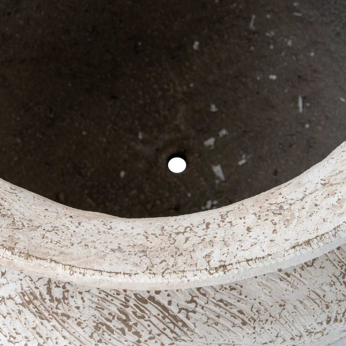 Close-up of the Hill Interiors Rustic Wash Concrete Planter showing the textured rim, weathered wash finish and deep interior with drainage hole.