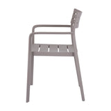 Side view of the Hill Interiors Stone Carver accent chair in beige moulded plastic, showing slatted seat, curved armrest and slim legs on a white background.