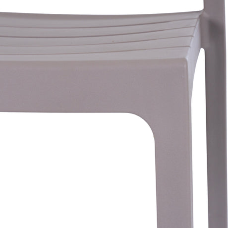 Close-up of the Hill Interiors Stone-Effect Moulded Accent Chair in beige, showing the matte plastic seat edge and squared front leg.