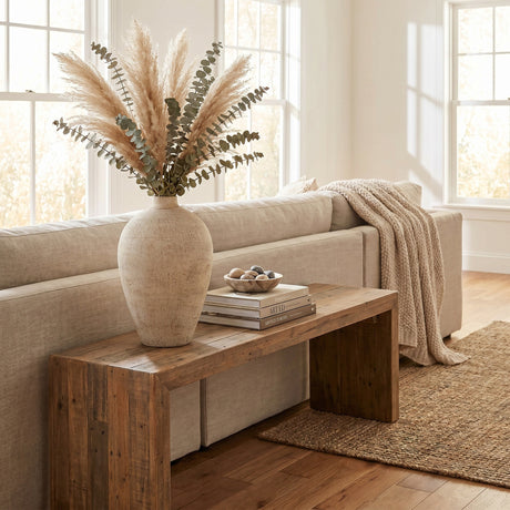 Hill Interiors Ceramic Medium Vase 28cm in cream holding pampas grass and eucalyptus on a reclaimed wood bench beside a linen sofa in a sunlit living room.