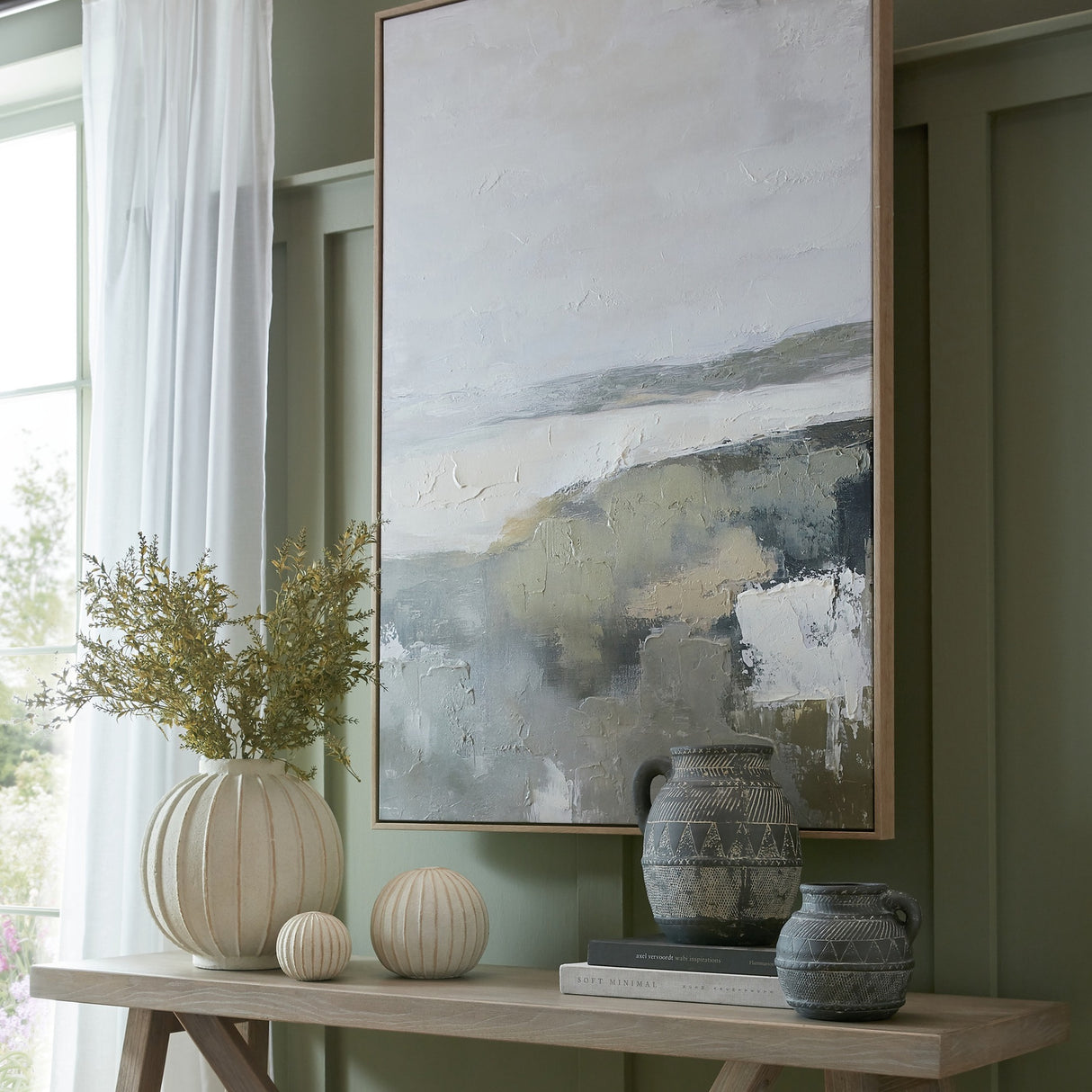 Hill Interiors Large Globe Ceramic Vase in white with vertical ribbing, holding yellow foliage on a wooden console beside decorative balls and dark jugs.