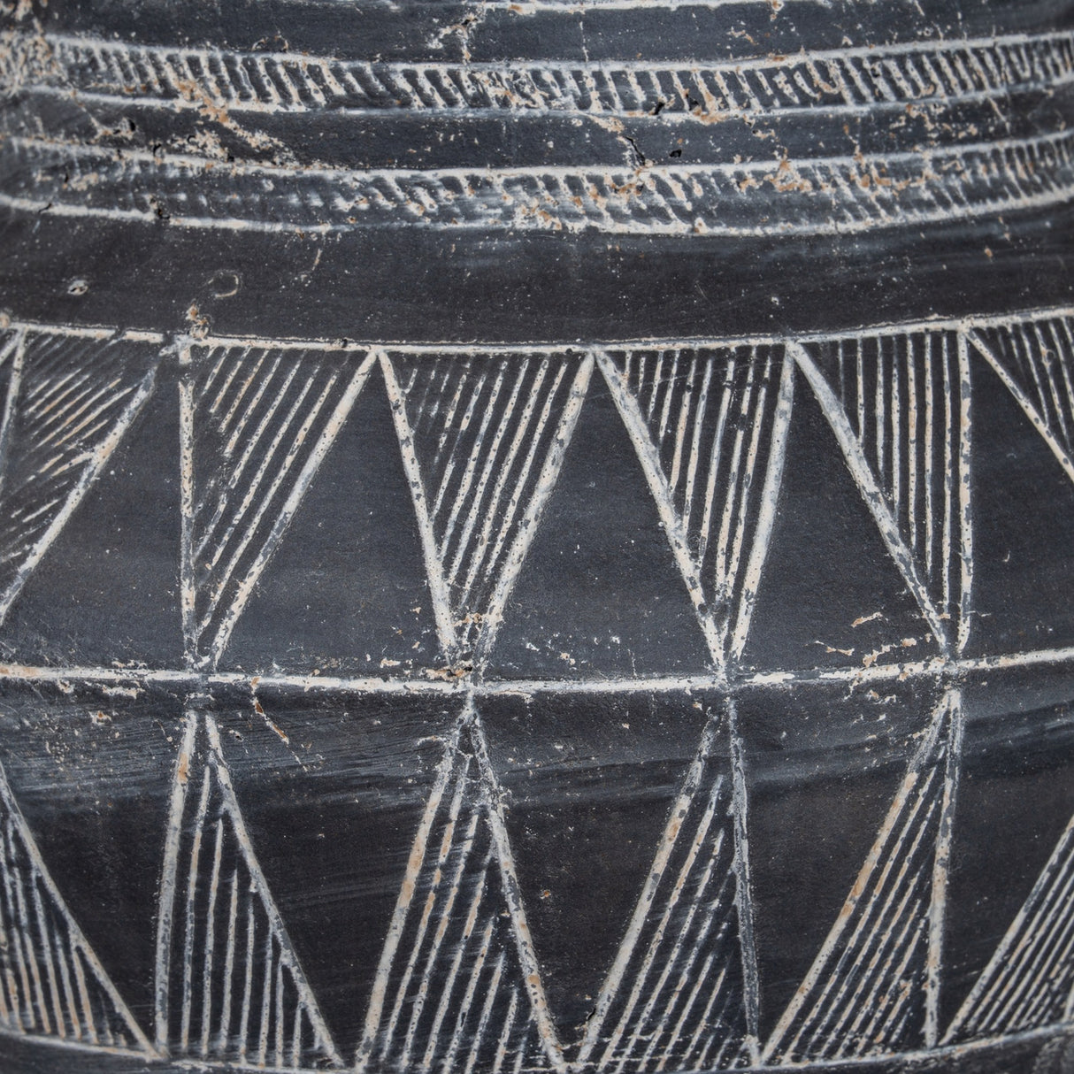 Close-up of the Hill Interiors Tall Etched Ceramic Planter in black, showing banded triangle etching and a smooth glazed finish with white detailing.