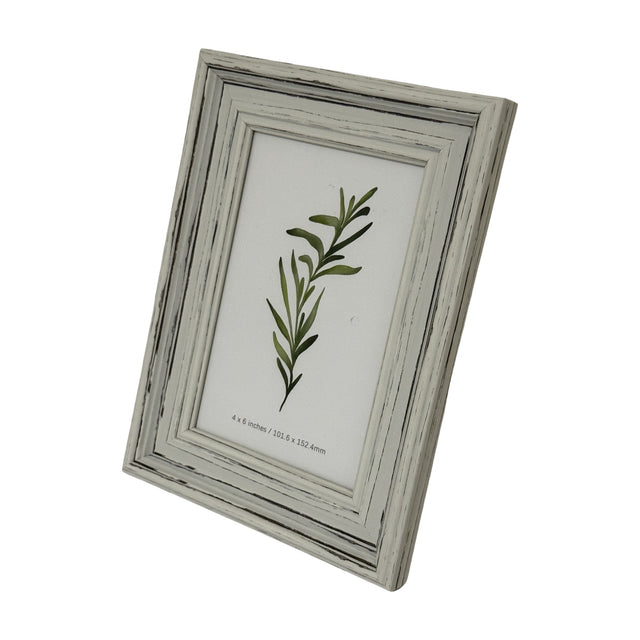 Hill Interiors White Wooden Photo Frame holding a 4x6in botanical print, shown at an angle with a distressed white painted wood finish on a plain background.