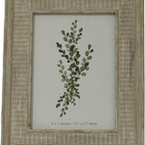 Hill Interiors white wooden 5x7in photo frame with textured painted finish, displaying a green botanical eucalyptus print behind glazing.