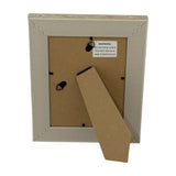 Back view of Hill Interiors white wooden photo frame showing kraft backing board, twin hanging hooks and fold-out easel stand on a white background.