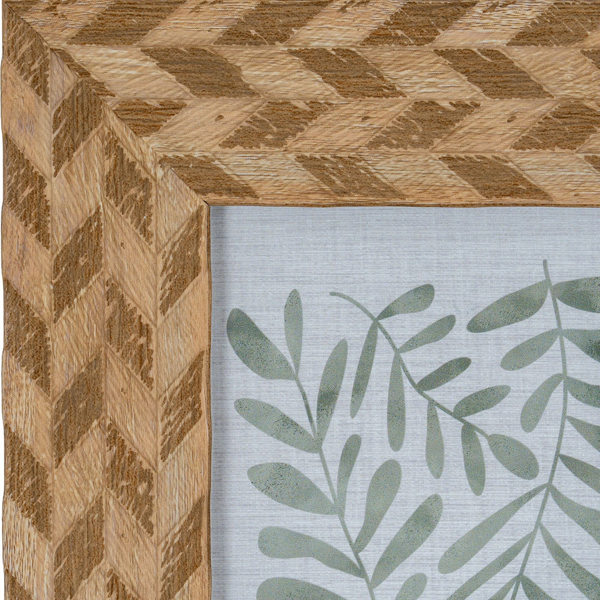 Close-up of Hill Interiors Wooden Photo Frame 4x6 in brown, showing the chevron-patterned wood grain corner and green botanical print inside.