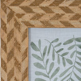 Close-up of Hill Interiors Wooden Photo Frame 4x6 in brown, showing the chevron-patterned wood grain corner and green botanical print inside.
