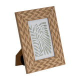 Hill Interiors wooden 4x6 photo frame in brown with a geometric chevron carved pattern, freestanding with rear kickstand, on a plain white background.