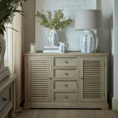 Hill Interiors Wooden Louvred Dresser Base in brown with two shuttered cupboard doors and four central drawers, styled with blue and white ceramics.