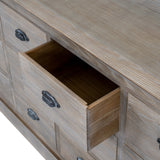 Close-up of the Hill Interiors 12 Drawer Wooden Chest of Drawers in brown, showing an open drawer with dovetail joints and a dark cup handle.