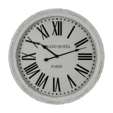 Hill Interiors Round Glass-Fronted Wall Clock in white with distressed wooden frame, black Roman numerals and "Grand Hotel Paris" text, on a white background.