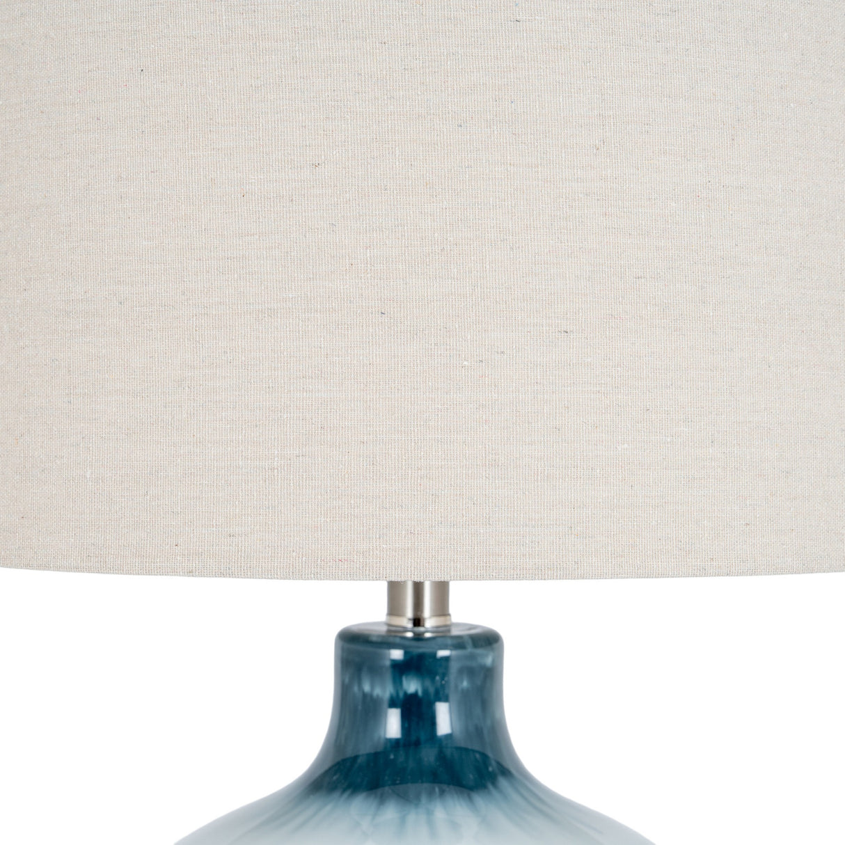 Close-up of Hill Interiors Glass Table Lamp showing the rippled blue moulded glass base and natural linen drum shade against a white background.