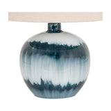 Hill Interiors Squat Glass Table Lamp base in rounded blue moulded glass with watery tonal variation, topped with a natural linen drum shade.