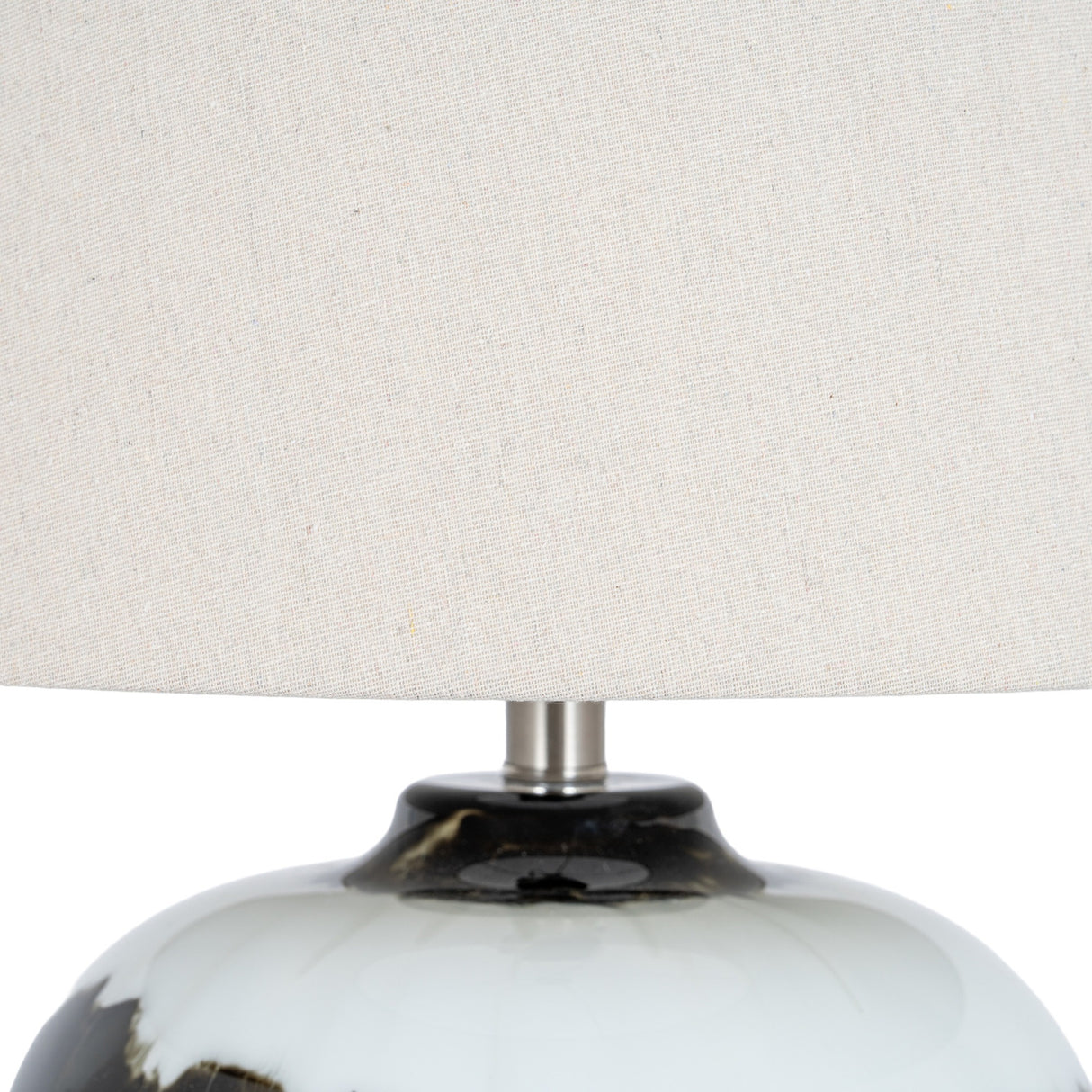 Close-up of the Hill Interiors Table Lamp with Linen Shade in Black, showing the glossy black glass base and natural linen drum shade.