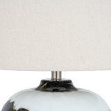 Close-up of the Hill Interiors Table Lamp with Linen Shade in Black, showing the glossy black glass base and natural linen drum shade.
